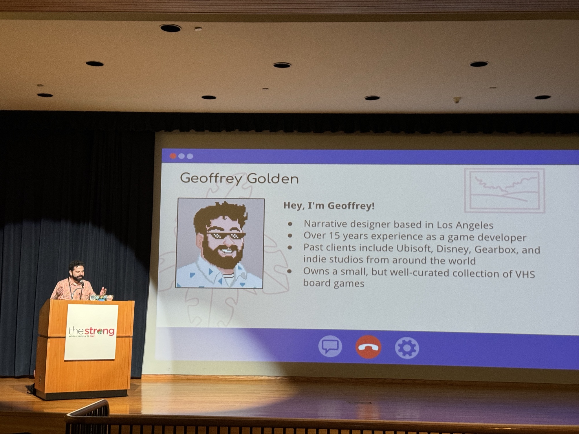 Geoffrey Golden at the lectern beside his introduction slide