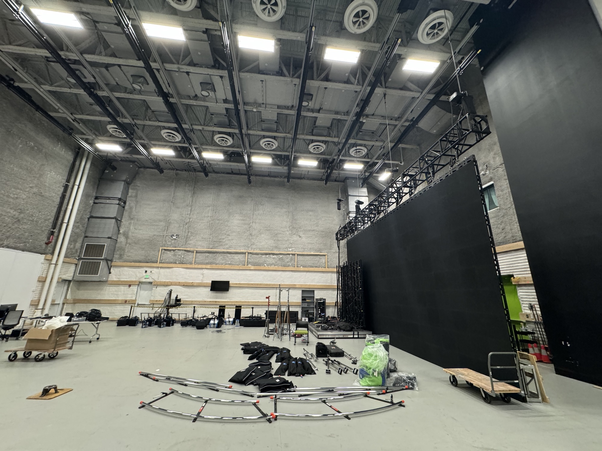 Inside the MAGIC Spell Studios sound stage, with an LED wall, overhead lighting grid and curved camera dolly track on the floor